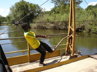 Pulling across the river using a piece of wood and steel wire