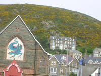 Hall with dragon, Barmouth. The yellow Broom on the hills is ubiquitous to Britain.