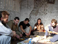 The guests eating a communal lunch