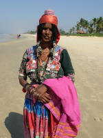 Sales Lady on the beach, selling sarongs and small jewelery boxes perched on her head