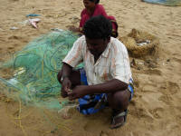 Fisherman taking the catch from the net
