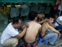 Tattoos being done in the street