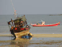 A ship stranded by the tide. It was being repaired during low tide.