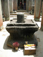 A lingum (Shiva) in a Yoni still being worshipped
