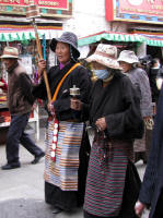 Twirling two different sizes of prayer wheels