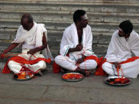 Priests preparing the string which is then wound around the wrists of pilgrims, Mysore, Kanataka, India